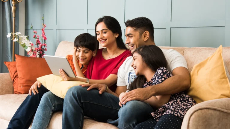 Indian Family with Tablet on Living Room Couch
